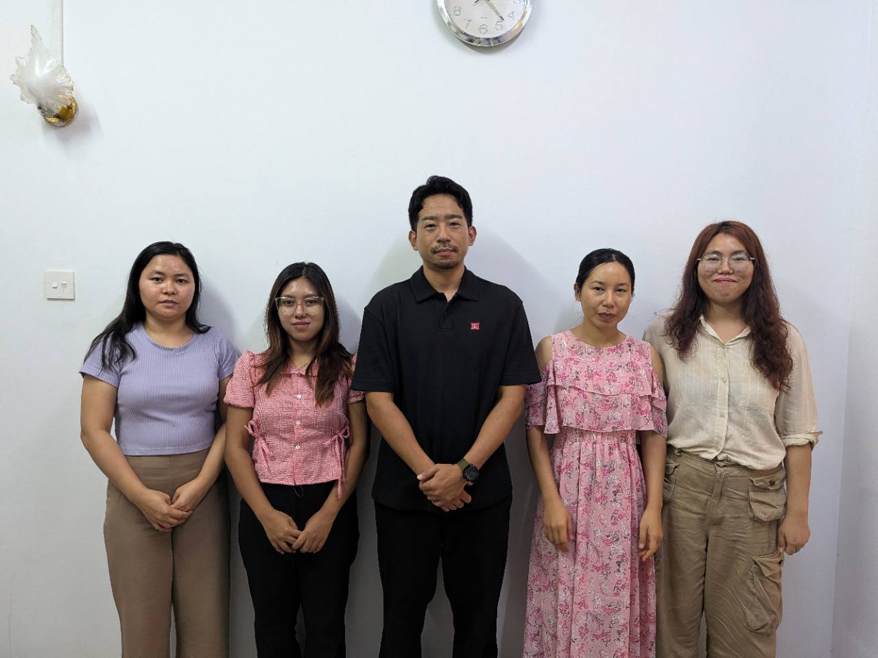 Yuhei Yamada, in the centre, standing with four colleagues